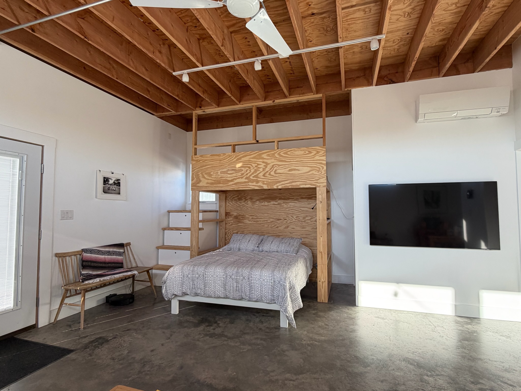 Main space — bed, loft, and TV